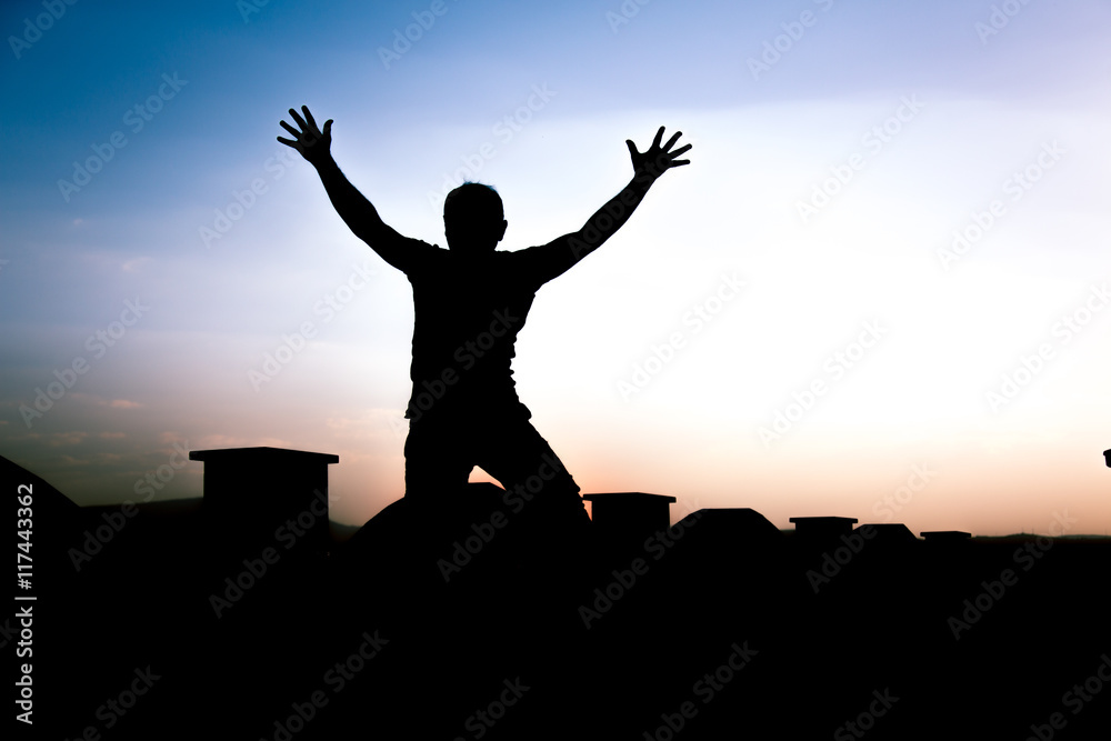 Defocused Silhouette of a boy is jumping over beautiful sunset background. Defocused Silhouette of a boy is jumping over beautiful sunset background.