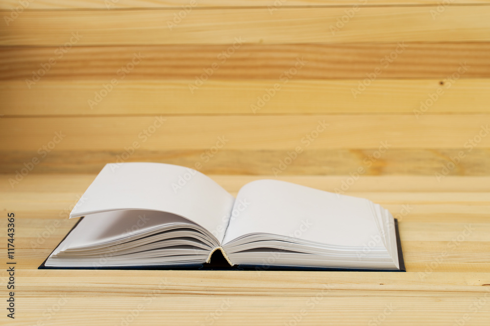 Open book, stack of hardback book on wooden table. Back to school. Copy space. Top view Open book, stack of hardback book on wooden table. Back to school. Copy space. Top view