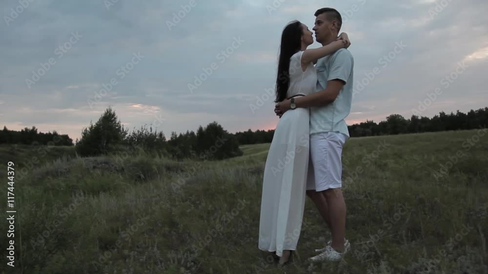 Lovers in the field. Guy hugs girl. Smile. Sunset. Lovers in the field. Guy hugs girl. Smile. Sunset.
