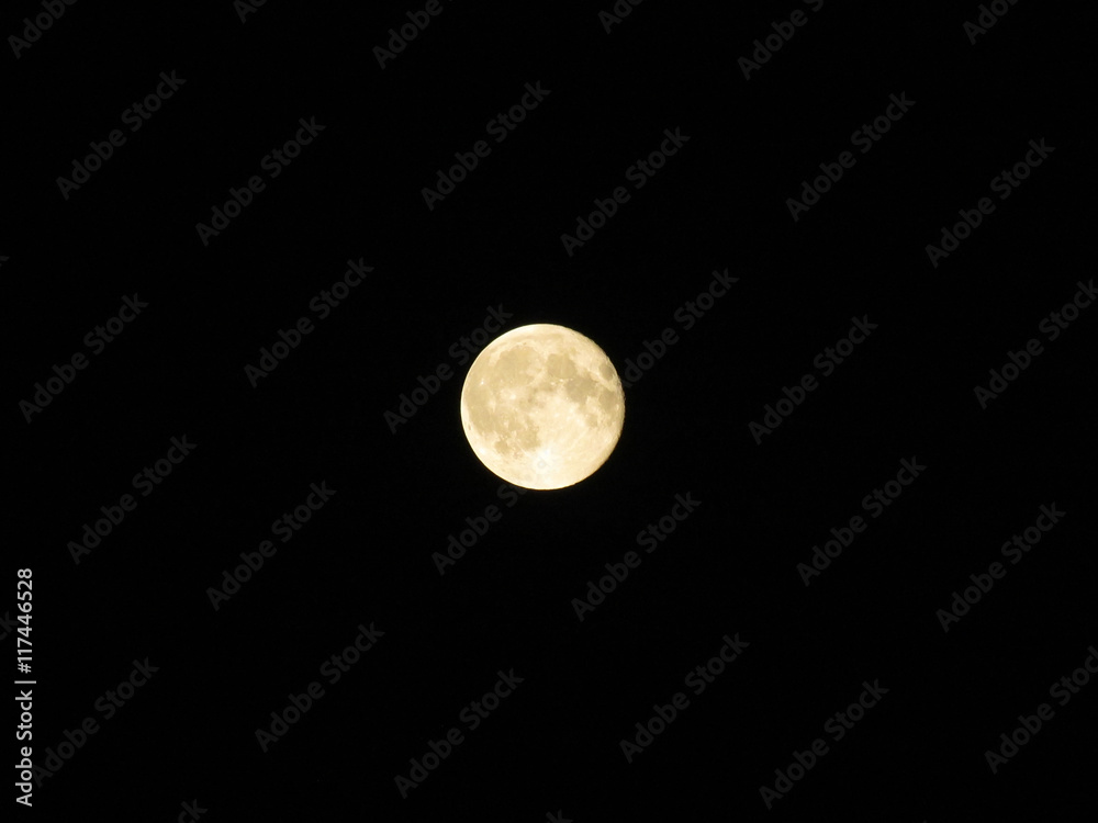 yellow moon against a black night sky yellow moon against a black night sky