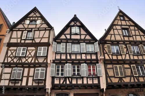  Front view of three old typical half-timbered houses. Colmar, Alsace, France.