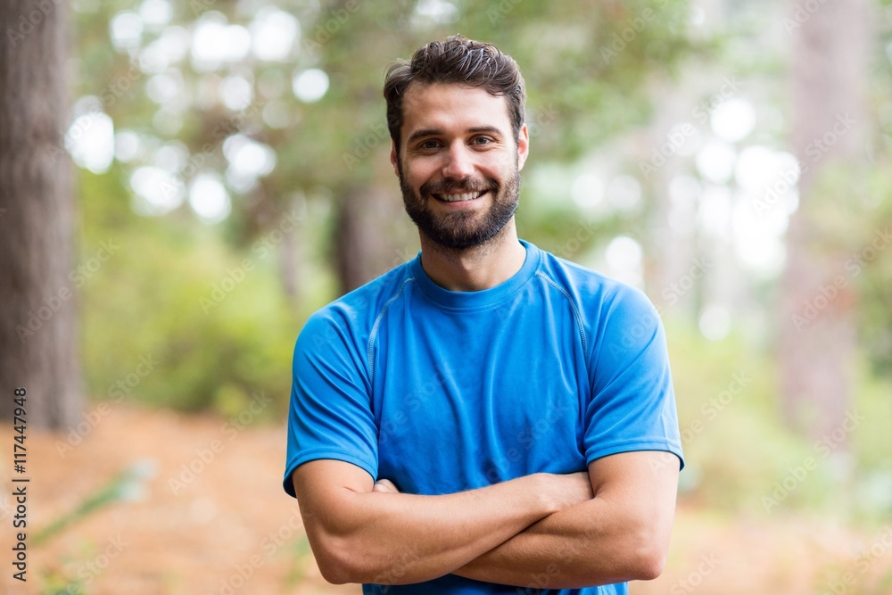 Man standing in forest with arms crossed Man standing in forest with arms crossed