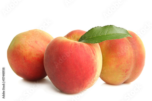 Peaches with leaf on white isolated background