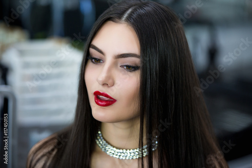 Young brunette girl with a diamond necklace