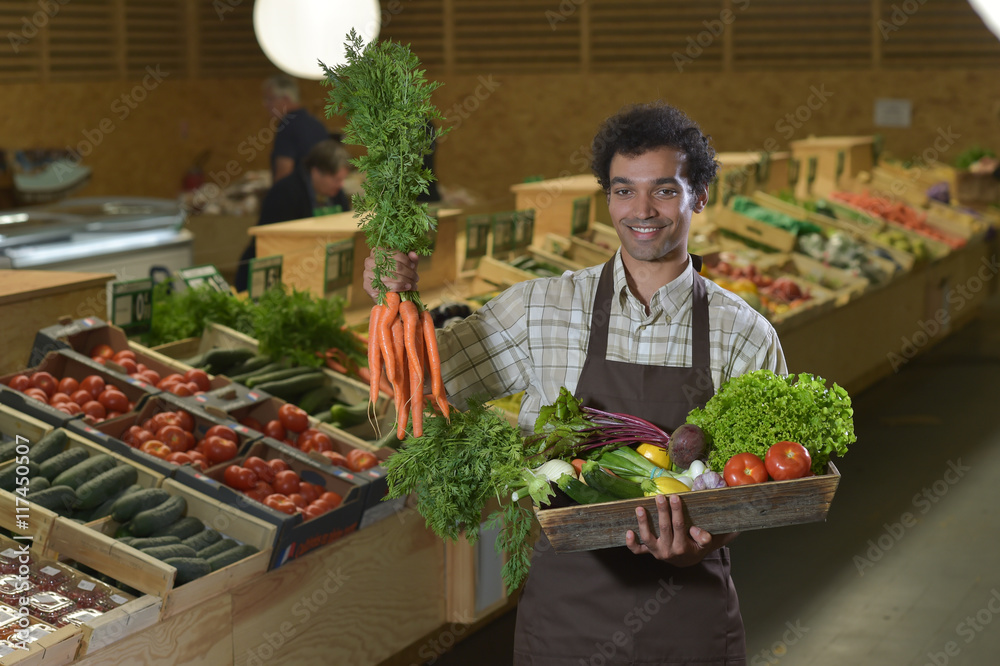 Grocery clerk working in produce aisle of supermarket store Grocery clerk working in produce aisle of supermarket store