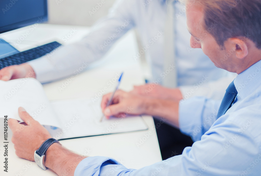 businessmen with notebook on meeting businessmen with notebook on meeting