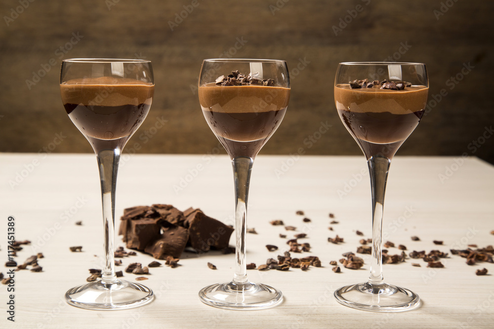 Chocolate mousse in a glasses on a wooden background Chocolate mousse in a glasses on a wooden background