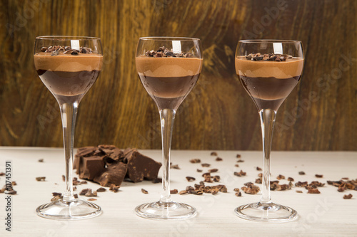 Chocolate mousse in a glasses on a wooden background