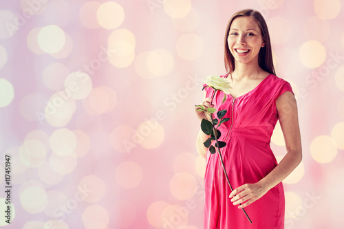 happy pregnant woman with rose flower
