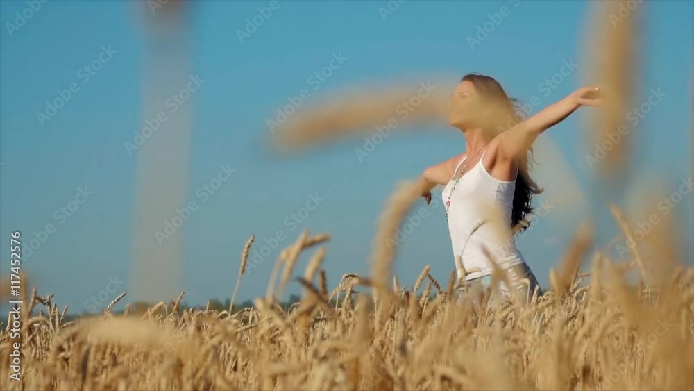 Happy woman in golden wheat