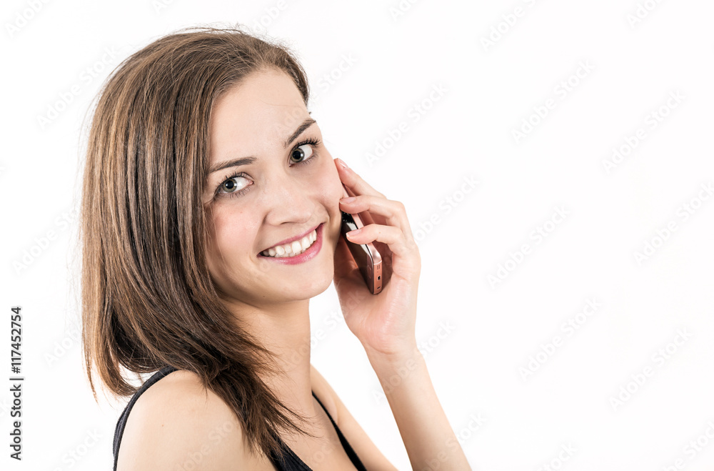 Young woman smiles while phones with a mobile Young woman smiles while phones with a mobile