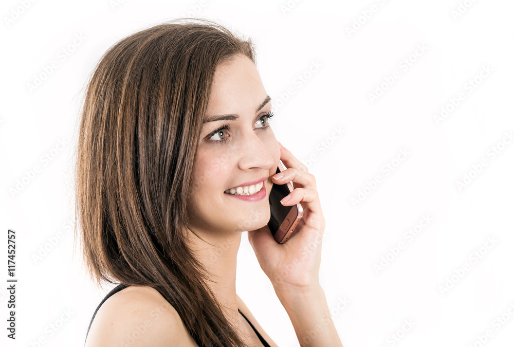 Young woman smiles while phones with a mobile