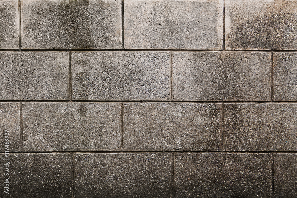 Naklejka premium Concrete block wall seamless background and texture
