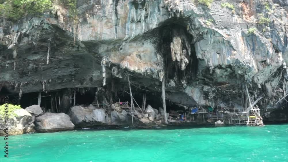 Bird nest cave in Koh Phi Phi island, Thailand. Beautiful mountain in green ocean Bird nest cave in Koh Phi Phi island, Thailand. Beautiful mountain in green ocean