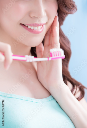 Beautiful woman holding tooth brush