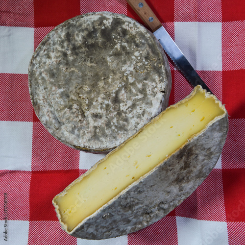 French tomme cheese for sale on a market stall photo