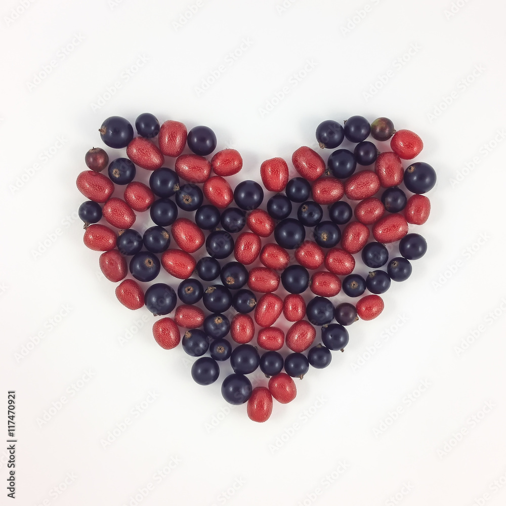 Heart shape made of currant and gumi berries on white background Heart shape made of currant and gumi berries on white background