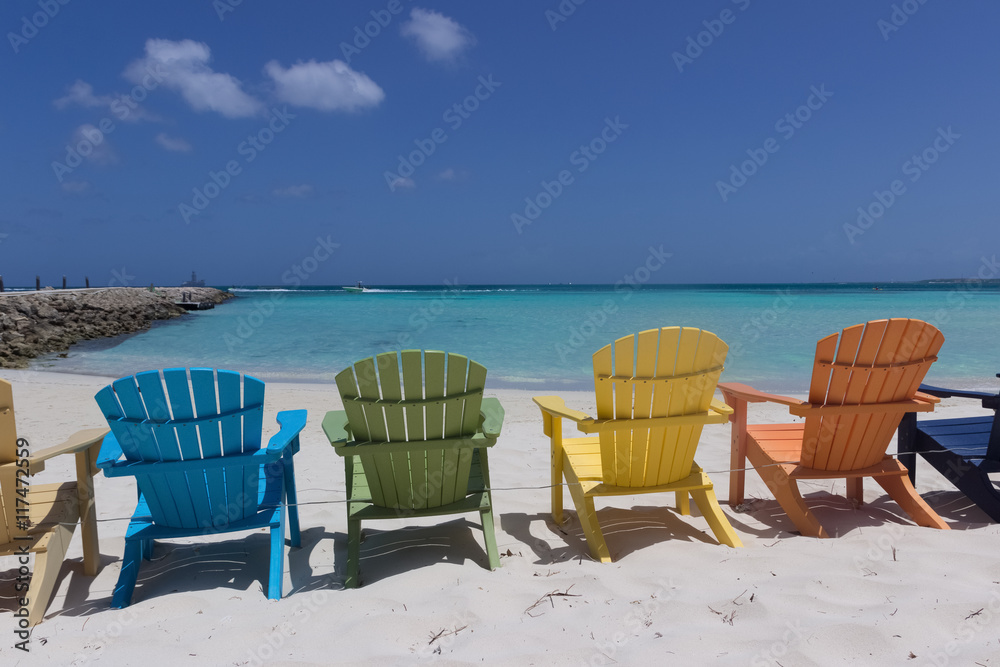 Colorful beach chairs on Caribbean coast in Aruba