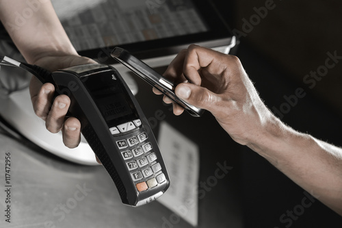 Payment in a trade with nfc system credit card.Customer paying