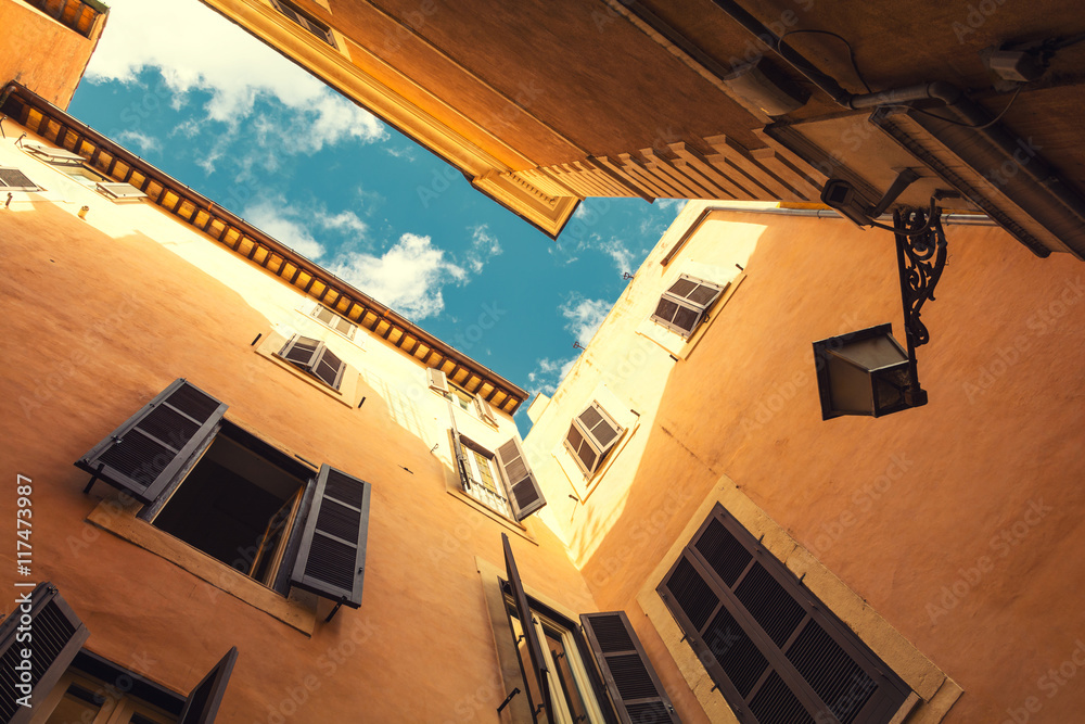 Fototapeta premium view from corner street in Rome to sunny sky