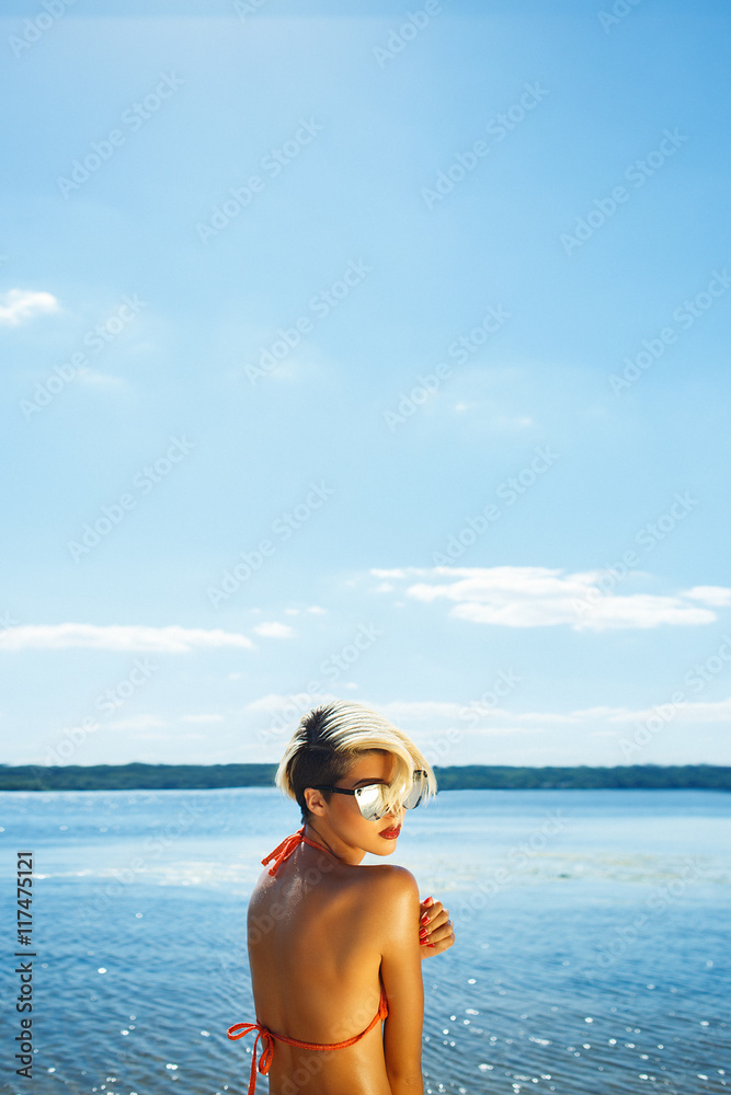 sexy blonde in swimsuit on beach looking at the sea sexy blonde in swimsuit on beach looking at the sea