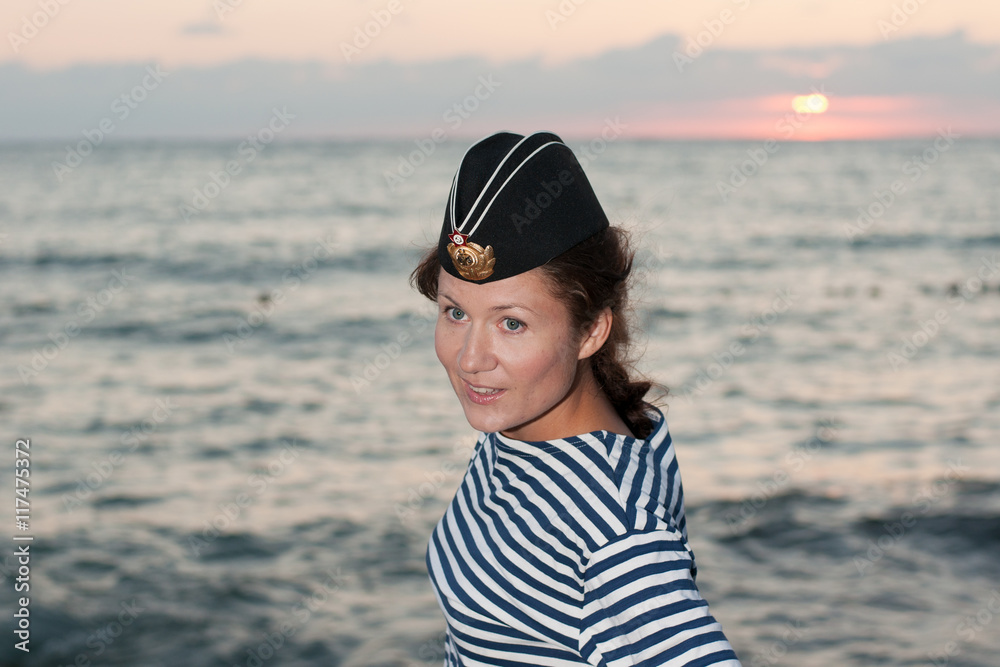 girl in a striped vest and his cap at the sea girl in a striped vest and his cap at the sea