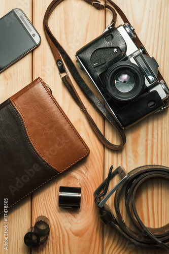 Camera, notebook and mobile phone on a wooden background. Still life. top view