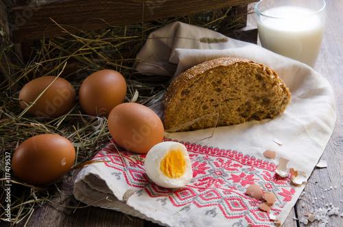 Rural breakfast. Vintage eggs on nest of straw background. Naturmort. Still life. photo