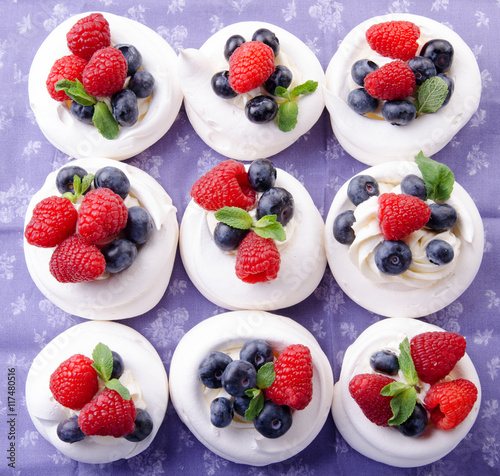 Homemade pavlova meringue cake with fresh berries and whipped cream. Morning. Dessert. Top view.