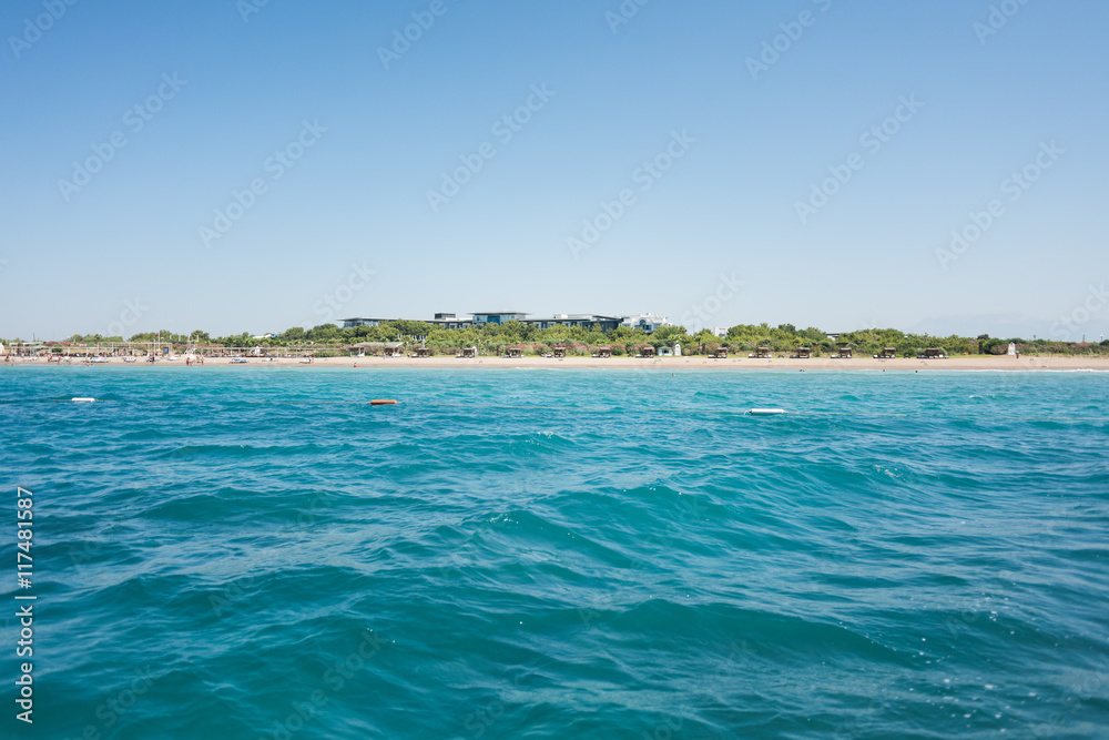 The Mediterranean sea view from the boat on the hotel beach with bungalows The Mediterranean sea view from the boat on the hotel beach with bungalows