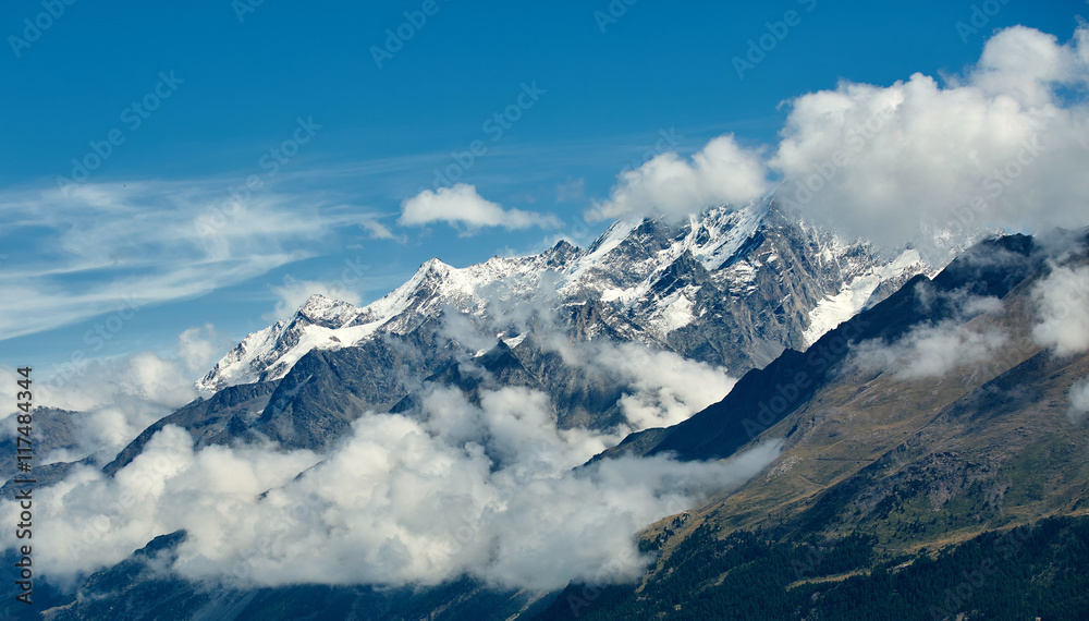 Snow capped alpine mountains. Trek near Matterhorn mount.