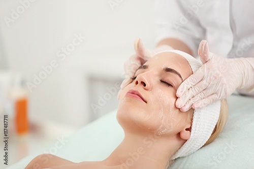 Cosmetologist applying crea...
