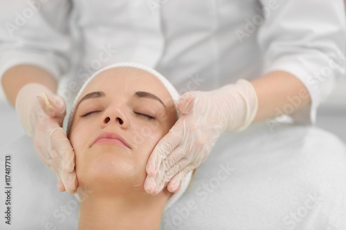 Cosmetologist applying crea...