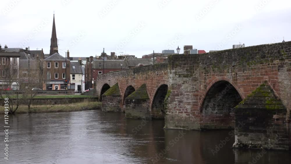 Dumfries Scotland arch Bridge over River Nith rainy day. Market town former royal burgh of Scotland. Founded during Roman occupation of North Great Britain. Dumfries Scotland arch Bridge over River Nith rainy day. Market town former royal burgh of Scotland. Founded during Roman occupation of North Great Britain.