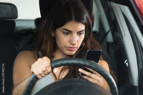 Fotografía Woman Inside Car Holding Mobile Phone