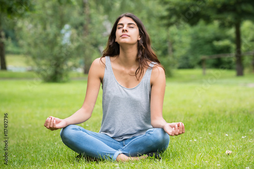 Woman Doing Meditation In Park