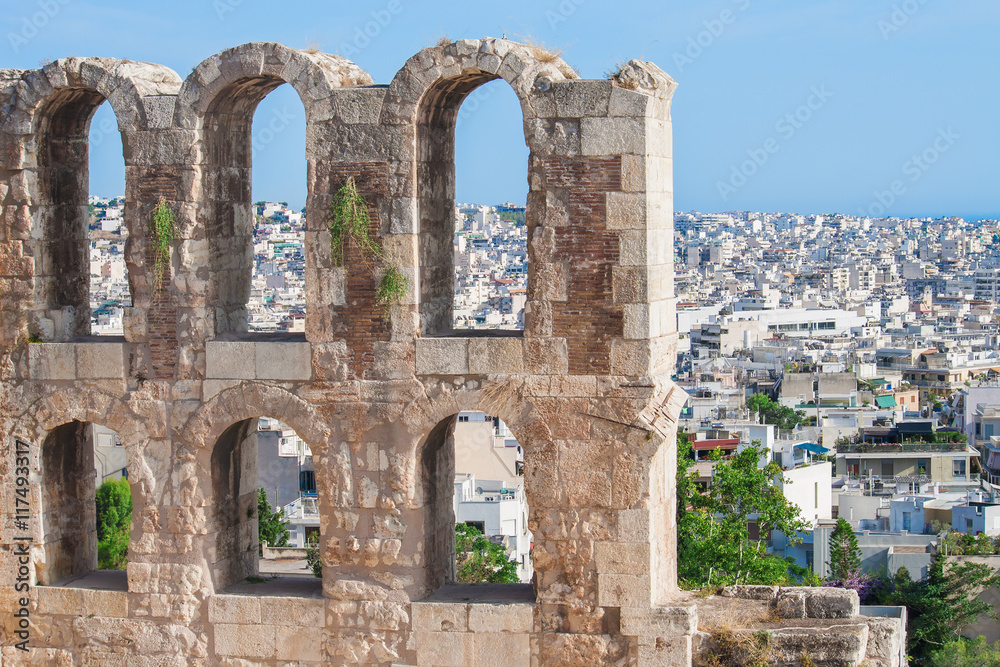 Present through the windows of the past - Landscape view of Athens, Greece through the archs of Herodes Atticus theater in Acropolis. 