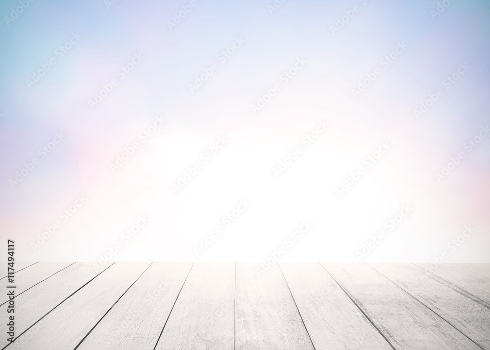 Old wood stage floor focus in the wooden foreground with blur abstract colorful background of blurred colorful purple sunset sky. Summer nature wallpaper of sunrise. Orange and purple clouds.