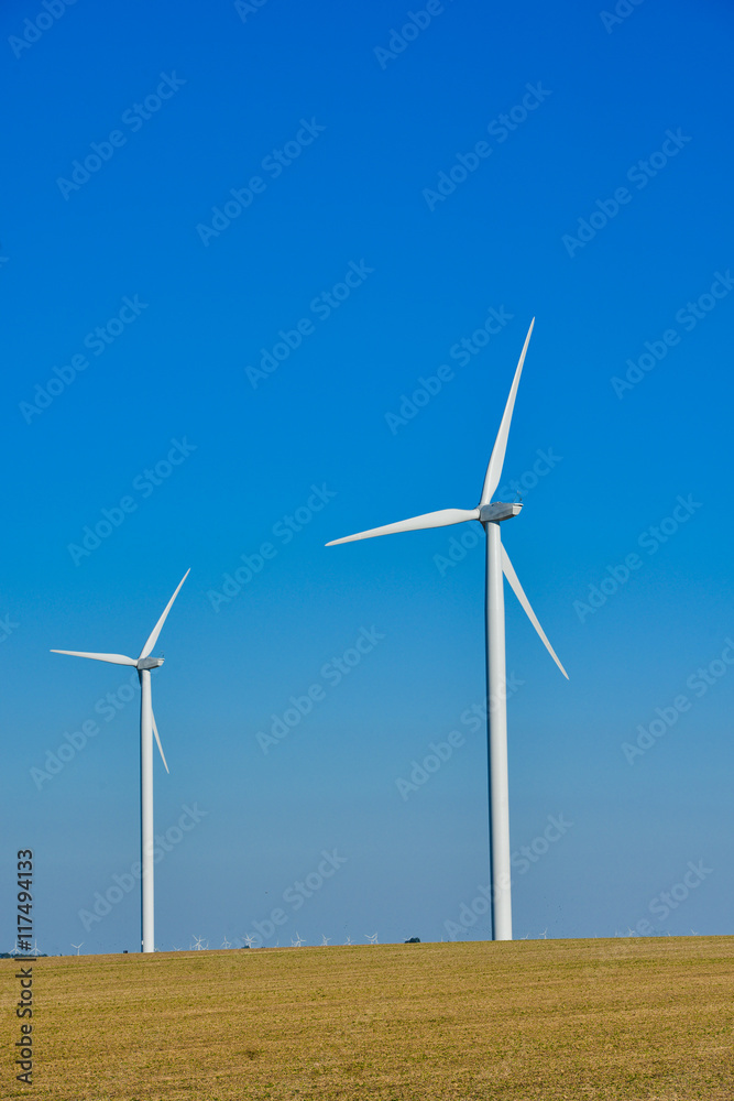 Windmills for electric power production on blue sky