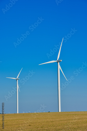 Windmills for electric power production on blue sky