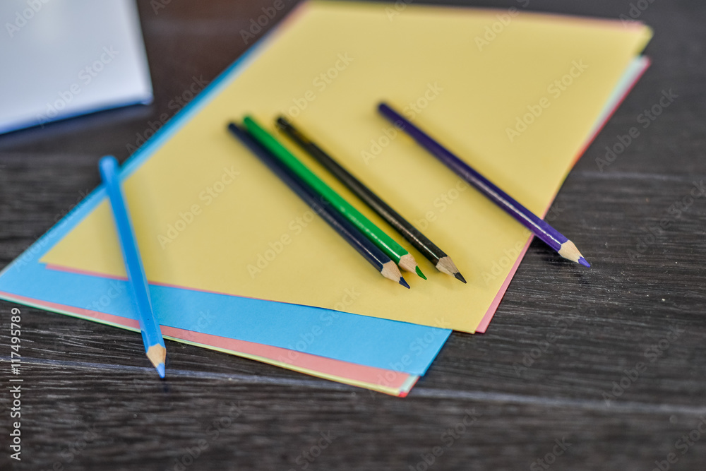 Blank paper and colorful pencils on the wooden table Blank paper and colorful pencils on the wooden table