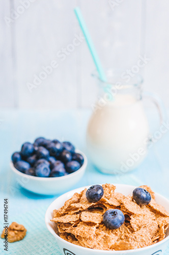 healthy breakfast, cornflakes blueberry and milk, nuts, almond with text space close-up