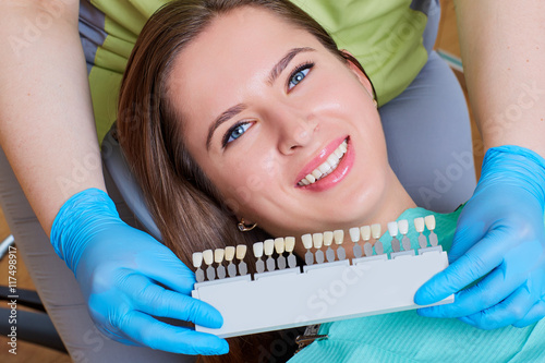 Close-up of a girl with a beautiful smile at the dentist.  Denta photo