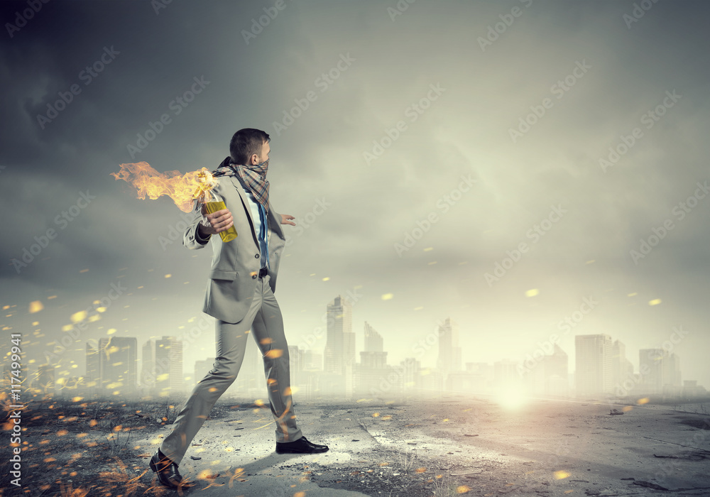 Businessman throwing petrol bomb . Mixed media Businessman throwing petrol bomb . Mixed media
