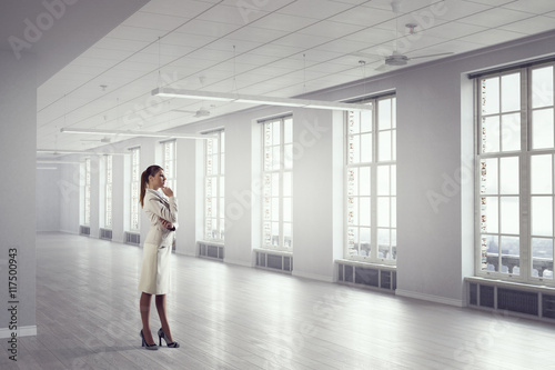 Businesswoman in modern office . Mixed media