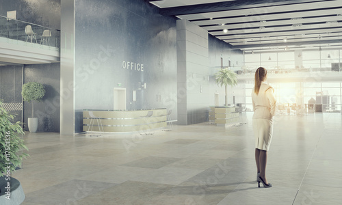 Businesswoman in modern office interior  . Mixed media