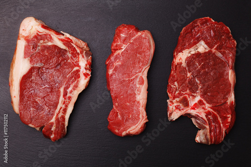Fresh, raw beef steak on a black stone tray
