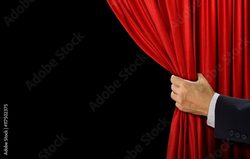 Hand open stage red curtain on black background photo