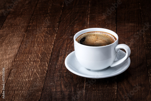 white mug of coffee on a wooden background