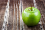 green apple fruit on a wooden background